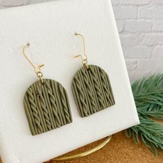 Fall and winter is just the season for sweater weather. And what better earrings to wear as these knit sweater weather earrings made from polymer clay but to look like a cable knit sweater! These dark green earrings are the perfect size to jazz up a simple outfit or pair with anything. A must-have for every earring enthusiast.  Our Sweater Weather Earrings are handcrafted in polymer clay and fired to create a beautiful piece that will last for years. The lightweight design adds a mix of fun and Weather Earrings, Dark Green Earrings, Simple Outfit, Earrings Polymer Clay, Animal Earrings, Lightweight Earrings, Green Earrings, Light Weight Earrings, Cable Knit Sweater