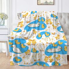 a blanket with ducks on it in a room