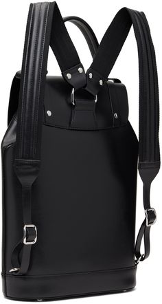 Buffed leather backpack in black. · Padded carry handle · Adjustable padded shoulder straps · Logo hardware and D-rings at face · Magnetic press-stud flap · Drawstring closure · Zip pocket at interior · Fully lined · H14.5 x W10 x D4.25 Supplier color: Black Modern Backpack With Palladium Hardware For Daily Use, Leather Backpack With Silver-tone Hardware For Travel, Leather Travel Backpack With Silver-tone Hardware, Modern Travel Backpack With Silver-tone Hardware, Everyday Backpack With Palladium Hardware, Modern Backpack With Gunmetal Hardware, Designer Backpack With Detachable Strap, Modern Leather Backpack With Gunmetal Hardware, Luxury Leather Backpack With Silver-tone Hardware