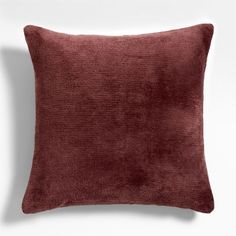 a red velvet pillow on a white background