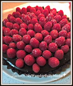 a chocolate cake with raspberries on top