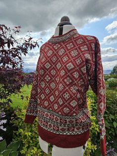 This beautiful, cosy jumper is knitted on my vintage hand-frame machine. All my knitwear is individually produced and finished by hand. This Corrachree design is available in a variety of colourways and sizes. Photo shows Blaze Red in size Medium: the main colour is a rich red with a fleck natural contrast and a border of brown, reds and natural white. Red Nordic Knitted Sweater, Red Nordic Style Knitted Sweater, Red Nordic Crew Neck Sweater, Red Nordic Sweater With Crew Neck, Scandinavian Hand Knitted Crew Neck Sweater, Nordic Crew Neck Knitted Sweater, Nordic Long Sleeve Knitted Sweater, Nordic Long Sleeve Hand Knitted Pattern, Nordic Crew Neck Knit Sweater