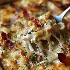 a spoon full of pasta with bacon and cheese