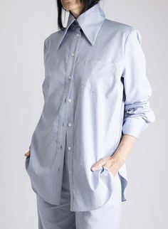 This style features:    - oversized collar  - button down front  - long sleeves with long cuffs  - rounded hemline  - oversized length  - fabric content: 100% cotton    - machine wash cold  - hang dry    style tip: keep it casual with your favorite jeans or pull on pants (like the jackie pant shown here) or dress it up with slacks and skirts. layer on top for even more drama!    also available in white.    sizing    this style fits true to size. sheila is 5'8 has a 34/b bust and 28" waist and is Big Collar Shirt, Big Collar, Oversized Collar, Oxford Blue, Collar Shirt, Pull On Pants, Favorite Jeans, Collar Shirts, Oxford