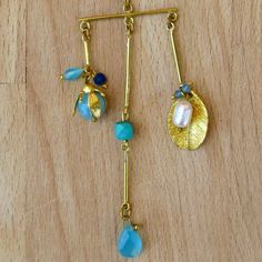 Single Brass & Natural Semi Precious Stones Earring available in.... Sweet Water Pearls, Rose Quartz & Chalcedony Sweet Water Pearls, Turquoise & Chrysocolla Sweet Water Pearls, Amethyst, Smokey Topaz & Chrysocolla Approx. Dimension & Weight 17.78x5.08cm (7.0x2.0in) 16.24g Material Info Size Chart Meaning: land of meadows (Hebrew origin) Pendant Earrings With Dangling Charms For Gifting, Pendant Earrings With Dangling Charms For Gifts, Pendant Earrings With Dangling Charms As Gift, Dangling Charms Pendant Earrings For Gift, Sweet Water, Smokey Topaz, Water Pearls, Semi Precious Stones, Stone Earrings