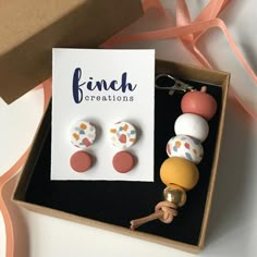 a box with three pairs of earrings in it and a card that says finch creations