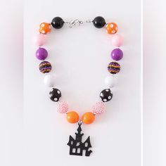 the necklace is decorated with colorful beads and an image of a castle on it's side