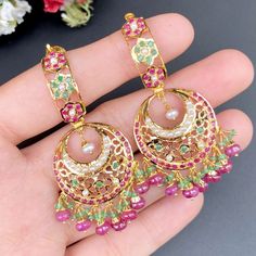 Featuring a pair of multicoloured traditional jadau earrings in 22ct gold. It has been embellished with pearls, rubies and emeralds. It weighs 18.5 GMs including 2.5 GMs of hanging beads Green 22k Gold Earrings With Intricate Design, Traditional Multicolor Hallmarked Earrings, Kundan Pearl Round Earrings In Temple Jewelry Style, Green 22k Gold Chandbali Earrings, Gold-plated Meenakari Bridal Earrings, Gold Plated Meenakari Bridal Earrings, Kundan Pearl Earrings For Temple Jewelry, 22k Gold Green Chandbali Earrings, Meenakari Gold Plated Bridal Earrings