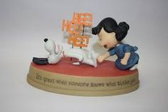 a figurine of a girl playing with a dog