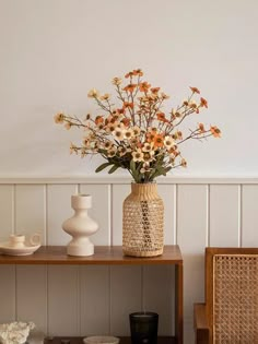 a vase filled with flowers sitting on top of a wooden table