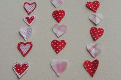 several hearts are arranged in the shape of small polka dots on a white tablecloth