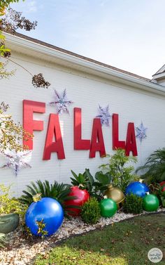 a sign that says falaa on the side of a building with christmas decorations around it