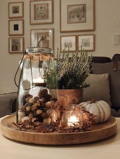 a table topped with a glass vase filled with flowers and candles next to a candle holder