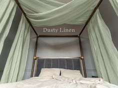 the canopy bed is made up with white sheets