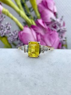 PRODUCT DESCRIPTION: Ring Information: Type: Statement Ring Fit: Comfort Metal: 925 Sterling Silver Plating: Vermeil Yellow Gold Total Stone Weight (ct.):  1.3 Product Weight:  2.63 grams Number of 7 x 5 mm Faceted Cut Yellow Sapphire:  1 Minimum Total Weight (ct.):  0.74 Average Color:  Yellow Average Clarity:  I2 Enhancement: Natural Setting Type:  Prong Number of 1.5 x .75 x .38 mm Taper Baguette Faceted Cut White Diamonds:  18  Minimum Total Weight (ct.):  .10 Average Color:  Colorless Avera Sapphire Band, Sapphire And Diamond Ring, Ring Fit, Yellow Sapphire, Precious Jewelry, Statement Ring, Rings Statement, Diamond White, Beautiful Earrings