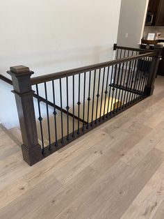 an empty room with wooden floors and railings