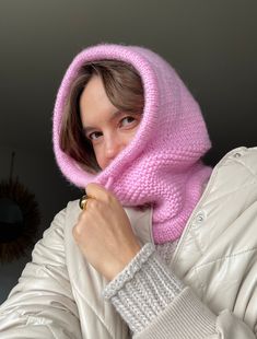 a woman wearing a pink hat and scarf