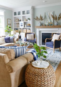 a living room filled with furniture and a fire place in the middle of a room