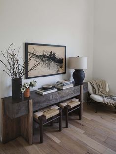 a living room with wood floors and a painting on the wall