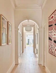 the hallway is lined with art and paintings