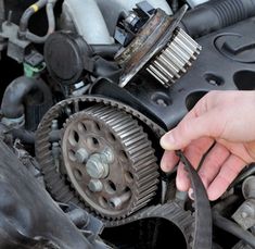 a man is working on an engine in his car