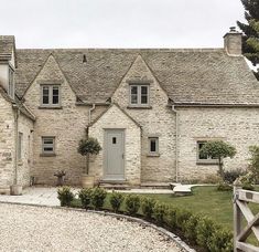 a stone house with a gray door and windows