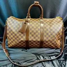 Elevate Your Travel Game With This Impeccable Louis Vuitton Keepall Bandouliere 45 In The Coveted Damier Ebene Pattern. Crafted With Precision And Finesse, This Iconic Piece Is Priced At $2,240, Obo. Immaculately Maintained In Excellent Condition, It Is A Testament To Timeless Elegance. Whether Jet-Setting Or City-Hopping, Its Spacious Interior Effortlessly Accommodates Your Essentials. Complete With Its Original Dust Cover, This Exquisite Bag Is An Investment In Both Style And Quality. Secure Your Statement Piece Now And Redefine Travel In Unparalleled Louis Vuitton Style. Louis Vuitton Keepall, Travel Games, Damier Ebene, Dust Cover, Jet Set, Womens Tote Bags, Travel Luggage, Luggage Bags, Travel Bags