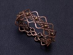 Handmade serpentine wire wrapped copper and 4 mm tiny bronze beads women weaved bracelet . Perfect gift for girlfriend , unique and special gift for wife for 7th copper wedding anniversary . Bracelet width : 2 cm - 0.8" Copper is oxidized to give it an antique appearance. Please read about copper care on Info & Faq section. The requested piece it's made to order similar with the original shown item . Please be sure to read the entire description of the item before you purchase. Item images may s Anniversary Bracelet, Leo Birthstone, Copper Wedding Anniversary, Statement Cuff Bracelet, Perfect Gift For Girlfriend, Copper Wedding, Tigers Eye Gemstone, Bracelets Handmade Beaded, Amethyst Purple