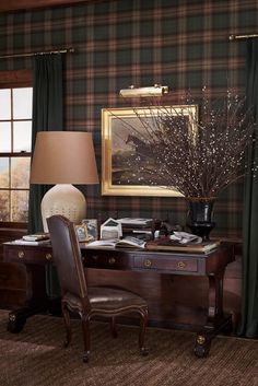 a chair sitting next to a desk with a lamp on it