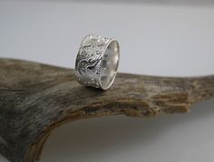 This wide floral band ring is made of 926 sterling silver. Very comfortable to wear as the inner side is not flat, but smoothened. When you purchase, please let us know the size in mm. 16,6 mm  (this size is 10.5 mm wide) 18 mm     (this size is 11 mm wide) 19,5 mm  (this size is 11.5 mm wide) 21 mm     (this size is 12 mm wide) IMPORTANT NOTE: All shipments are sent with a tracking number. When you purchase, please don't forget to add also your phone number. Sterling Silver Wide Band Promise Ring, Sterling Silver Wide Band Ring In White Gold, Hallmarked Sterling Silver Wide Band Ring, Silver Engraved Wide Band Promise Ring, Silver Wide Band Promise Ring, Wedding Engraved Ring, Stamped 925, Wide Band, Silver Engraved Ring With Decorative Wide Band, Silver Engraved Wide Band Ring With Decorative Detail, Engraved Wide Band Promise Ring