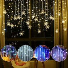 snowflakes are hanging from the ceiling in front of a window with curtains and lights