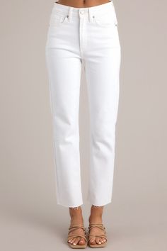 Close up view of these jeans that feature a high-rise waist, a scissor cut-off hem, functional pockets, belt loops, and a zipper button closure. White High Rise Flare Jeans With Frayed Hem, White High-rise Flare Jeans With Frayed Hem, White Mid-rise Pants With Frayed Hem, White Straight Leg Jeans For Spring, Chic White Denim Jeans, White Denim Jeans With Frayed Hem, High Rise White Pants With Frayed Hem, White High Rise Pants With Frayed Hem, White High-rise Pants With Frayed Hem