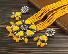 This is a stunning handmade necklace perfect for high end Jewelry Collector, a keeper in Traditional Vintage Indian/Pakistani Bridal jewelry and a Luxury Gift for your Daughter, Sister or Wife on Wedding or Anniversary. Perfect for any type of occasions, weddings And celebrations and a beautiful & memorable gift for weddings and special occasions. -Item Code:- L2405 -Yellow Beaded Rajwada Necklace Set with Earrings. -Designer necklace multi layered Yellow beaded mala with Kundan pendant. -Gold Plated Set with Kundan Stones which shine like Polki Diamonds. -Metal: Black oxidized brass -Earrings are 65mm long and 27mm wide -Push Back Earrings -Necklace length with pendant 12" approx excluding dori/cord -Quantity:- One Necklace Set Please see more different designs here:- https://www.etsy.com Luxury Kundan Jewelry In Yellow Gold, Polki Diamond Necklace, Yellow Beaded Necklace, Pakistani Bridal Jewelry, Necklace Set With Earrings, High End Jewelry, Designer Necklace, Pakistani Jewelry, Vintage Indian