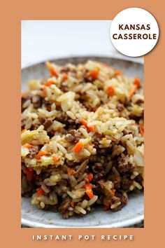 a white plate topped with rice covered in meat and veggies next to a brown background