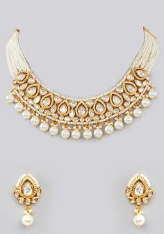 Featuring a Kundan Gold Pearl Necklace Set studded with Kundan stones adorned with faux diamonds in a tear drop pattern, set in mixed metal with gold plating. It is paired with a matching pair of earrings. Perfect for wedding and festive occasions. Composition : Mixed Metal Care: Avoid exposure to water and perfume. Store in dry plastic or fabric pouch. To clean, use a soft cloth to wipe the jewellery. Delivery : 6-8 weeks as the product is hand crafted. For more information and sizes please contact fabiliciousfashion@gmail.com or visit our Copenhagen studio. About the Designer : If you're a bride-to-be or simply someone who loves exquisite jewellery, then Zevar by Geeta is the brand for you! Geeta Sangra is a master at blending traditional Indian themes with modern fashion trends, resulti Gold Teardrop Jewelry Sets For Celebration, Temple Jewelry Teardrop Earrings For Celebrations, Festive White Jeweled Kundan Necklace, White Jeweled Kundan Necklace For Festivals, Gold Bridal Necklace With Gota Work For Celebration, Gold Teardrop Jewelry For Festive Occasions, White Teardrop Jewelry Sets For Party, White Teardrop Jewelry For Celebration, Traditional Teardrop Bridal Necklace For Festive Occasions