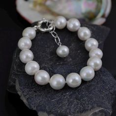 Material        : 10-12mm Natural White Baroque Pearls in 14K Gold Plated with Cubic Zirconia Clasp  Quantity       : One Piece Pealr Color   :  Natural White Baroque Pearl Shape           : Irregular / Potato as pictured Length          : Please choose size from the option menu ** If you need larger or smaller on the length of the bracelet, please feel free to convo us, thank you for shopping with us ** Lead Time & Shipping :  This is an order to make item.  We will ship your order in 1-3 business days to you once we received your order.   If we offered FREE DOMESTIC shipping, package will be shipped via USPS First Class mail on orders shipping within the U.S. W H O L E S A L E    I N Q U I R Y :- Please convo us at anytime if you need to purchase in Wholesale Quantity and Custom Made Ord Cultured Pearl Bracelet, White Pearl Bracelet, Bridal Bracelet, Baroque Pearls, White Pearl, Cultured Pearls, Pearl Bracelet, Link Bracelets, Pearl White