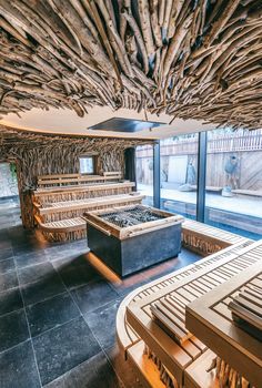 a room filled with lots of wooden furniture and walls covered in wood planked ceilinging