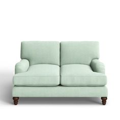 a light green couch sitting on top of a white floor