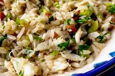 a blue and white plate topped with rice and veggies