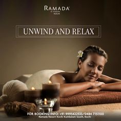 a beautiful woman laying on top of a towel next to candles and an unwind and relax sign