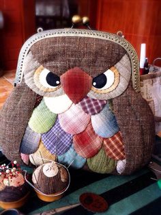 an owl purse sitting on top of a table next to cupcakes