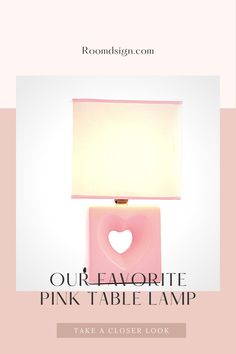 a pink table lamp with a heart shaped light on it and the words our favorite pink table lamp take a closer look