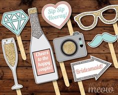 wedding photo booth props with champagne, glasses and mustaches on wooden planked background