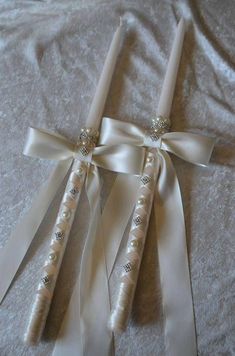 two white wedding garters with pearls and ribbons