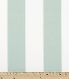 a ruler is shown next to a striped wallpaper in mint green and off white