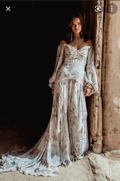 a woman standing in front of a door wearing a dress