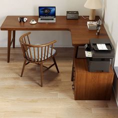 a wooden desk with a laptop on top of it next to a chair and lamp