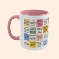 a pink and white coffee mug with words on it