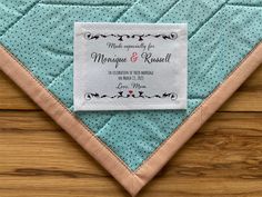 a blue and white wedding handkerchief on top of a wooden table with a label that says, we are engaged for marriage & russell