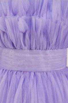 a purple dress with ruffles on it